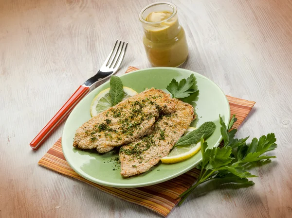 Breaded cutlet with herbs and mustard — Stock Photo, Image