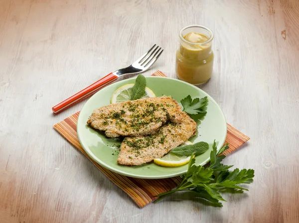 Breaded cutlet with herbs and mustard — Stock Photo, Image