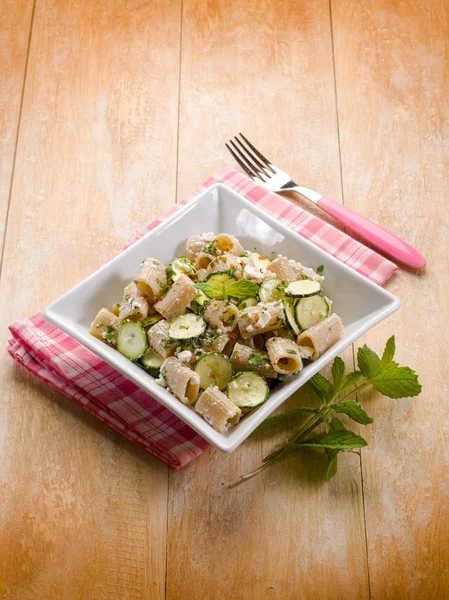 Pasta with feta cheese zucchinis and mint leaf — Stock Photo, Image