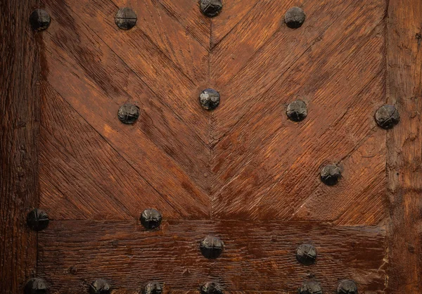 Old wooden door texture with metal nails — Stock Photo, Image