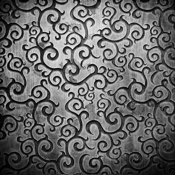 Ornamento intagliato nero su texture in legno — Foto Stock