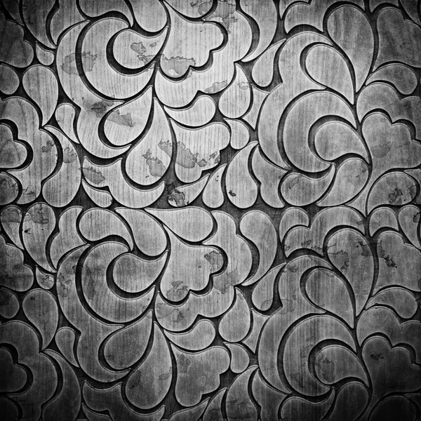 Черный резной орнамент на деревянной текстуре — стоковое фото