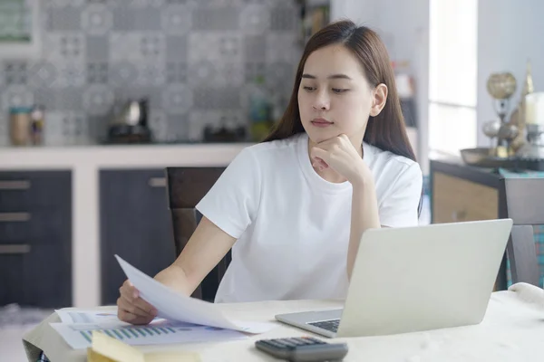 Attractive young Asia woman working at home. Working and learning from home