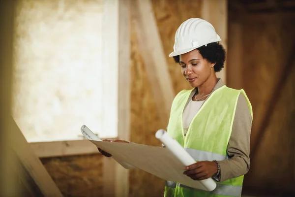 Shot African Female Architect Checking Blueprints Construction Site New Wooden — Stock Photo, Image