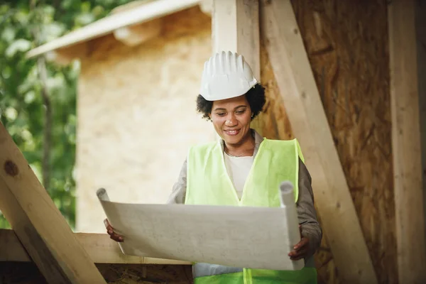 Shot African Female Architect Checking Plans Construction Site New Wooden — Stock Photo, Image