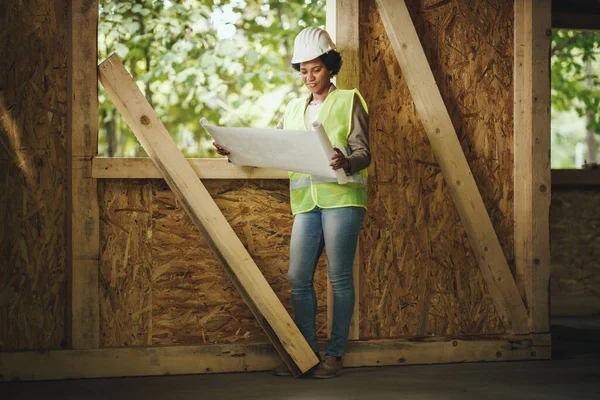 Shot African Female Architect Checking Plans Construction Site New Wooden — Stock Photo, Image