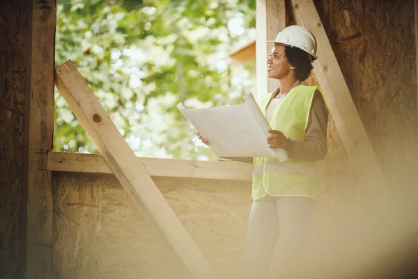 Shot African Female Architect Checking Plans Construction Site New Wooden — Stock Photo, Image