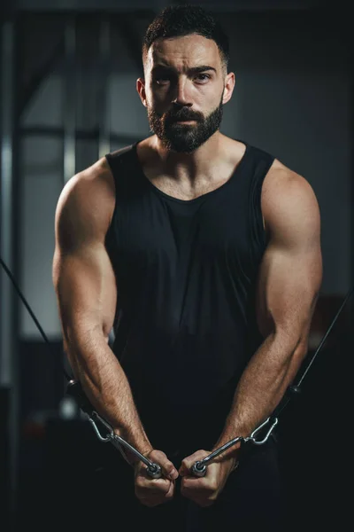 운동복입은 근육질의 남자가 장에서 운동하는 장면이요 케이블 기계에 가슴을 운동을 — 스톡 사진