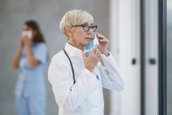 Tired Senior Doctor Protective Mask Pensive Looking Out Window While — Stock Photo, Image