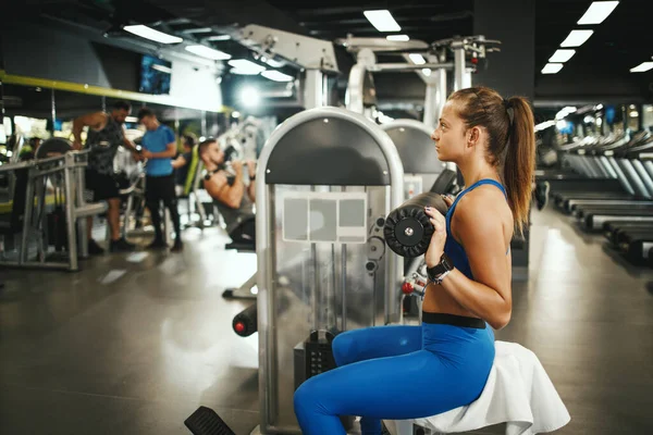 Tiro Una Joven Musculosa Ropa Deportiva Haciendo Ejercicio Máquina Gimnasio — Foto de Stock