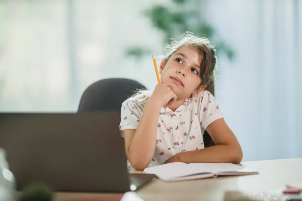 Cute Pensive Little Girl Using Her Laptop Doing Homework Assignment — Stock Photo, Image