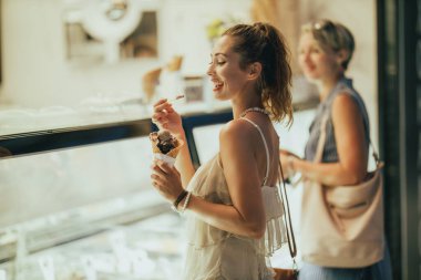 Dondurmadan zevk alan çekici genç bir kadının portresi..