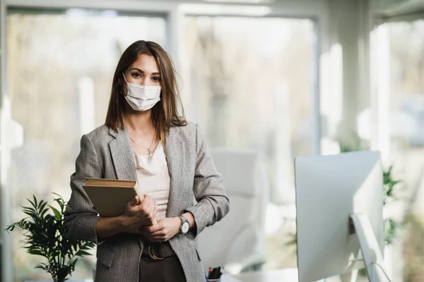 Een Succesvolle Jonge Zakenvrouw Met Chirurgisch Masker Haar Kantoor Kijkend — Stockfoto