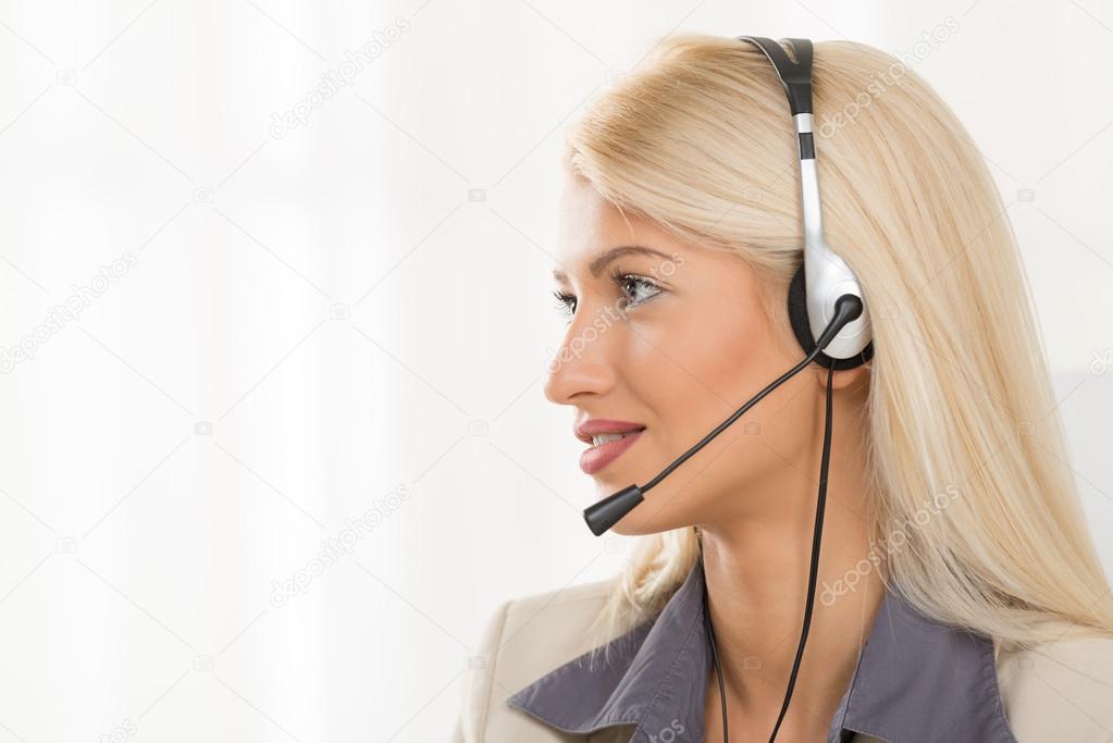 Young Blond Woman With A Headset