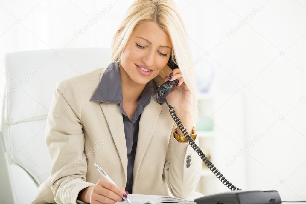 Businesswoman Phoning In Office