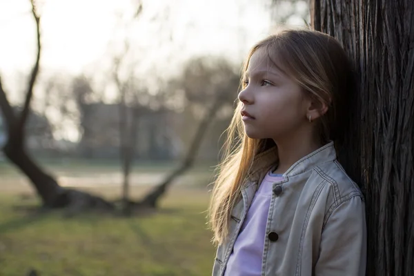 Pensive Little Girl Beside A Tree — Stock Photo, Image