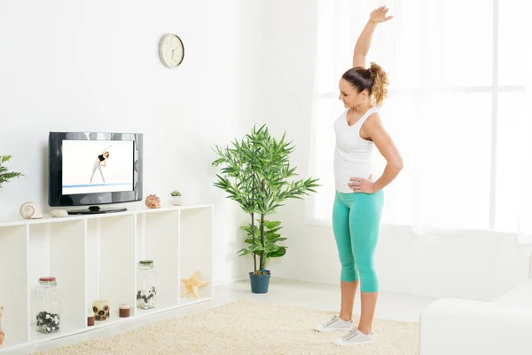 Giovane donna che fa esercizi di stretching — Foto Stock