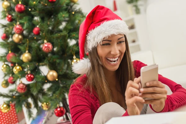 Meisje met Santa's Hat en slimme telefoon — Stockfoto