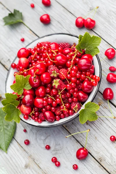 Fruit bowl full cherries raspberries — Stock Photo, Image