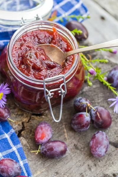 Słoje (słoiki) śliwki jam drewniany stół — Zdjęcie stockowe