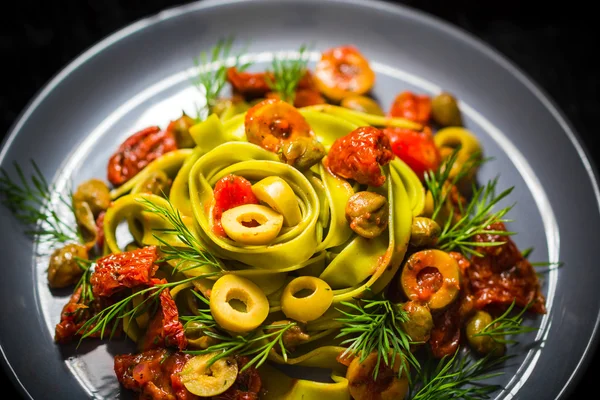 Warm lunch Pasta tomato sauce capers asparagus Magic light — Stock Photo, Image