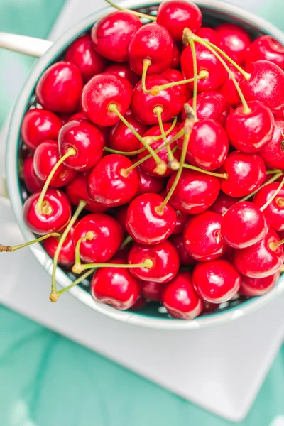 Fresh red cherry fruit green colander — Stock Photo, Image