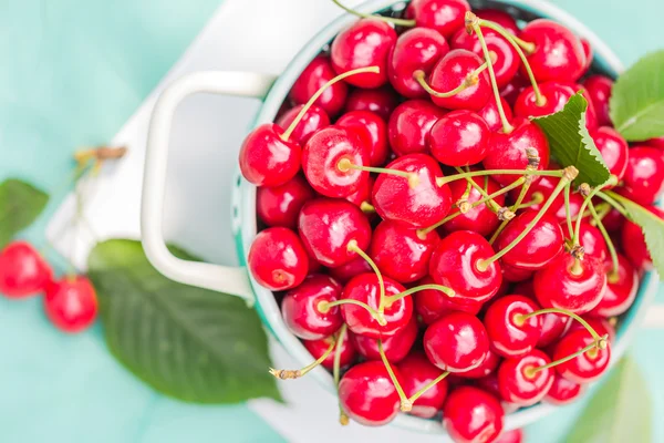 Fresh red cherry fruit green colander — Stock Photo, Image