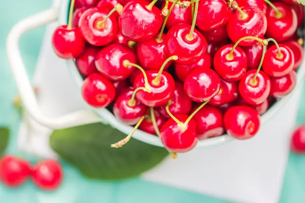 Fresh red cherry fruit green colander — Stock Photo, Image