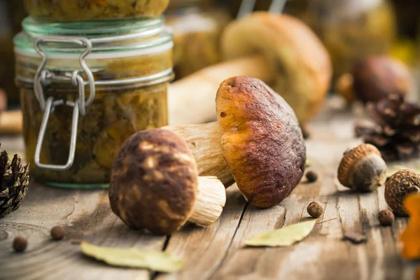 Marinated mushrooms jars wooden table — Stock Photo, Image