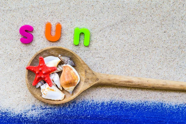 Word sun laid sand blue board — Stock Photo, Image