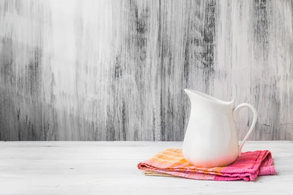 Still life white jug kitchen cloth — Stock Photo, Image