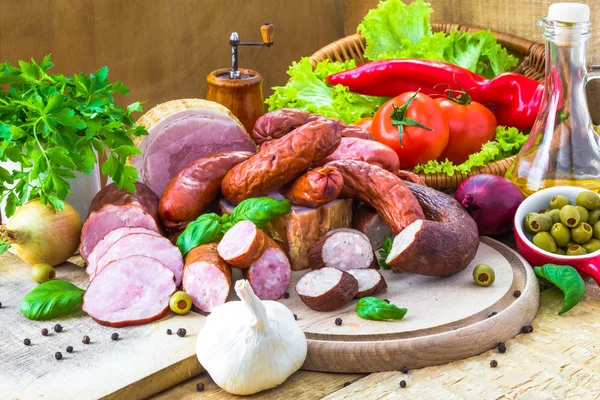 Assortment meats sausage bacon green — Stock Photo, Image