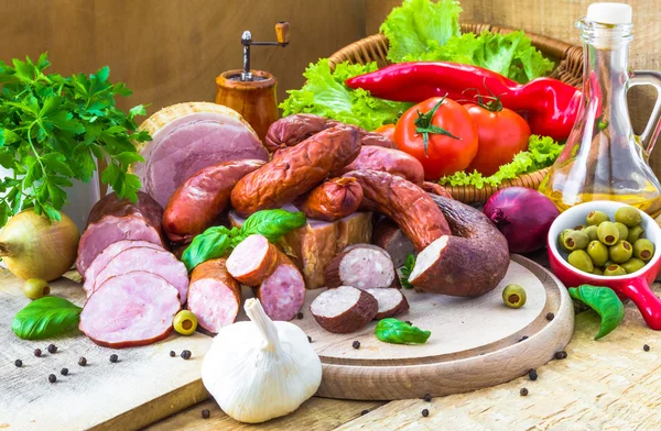 Assortment meats sausage bacon green — Stock Photo, Image