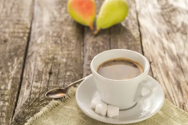 Кофе чашка черная деревянная доска коричневые груши белые — стоковое фото