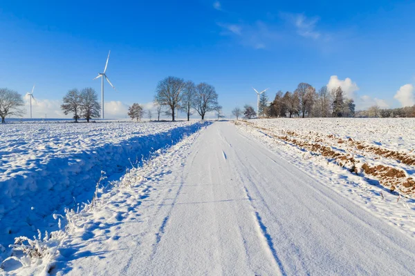 Winter landscape road snow covered fields windmills — Stock Photo, Image