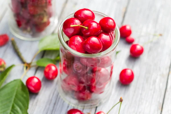 Gläser voll frisch gepflückter Kirschen Himbeeren — Stockfoto