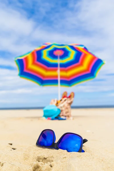 Blue sunglasses umbrella background — Stock Photo, Image