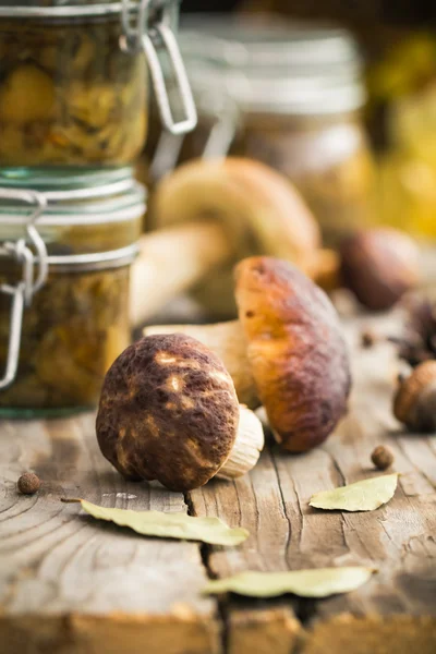 Marinated mushrooms jars wooden table — Stock Photo, Image