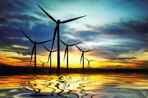 Beautiful sunset above the windmills on the lake