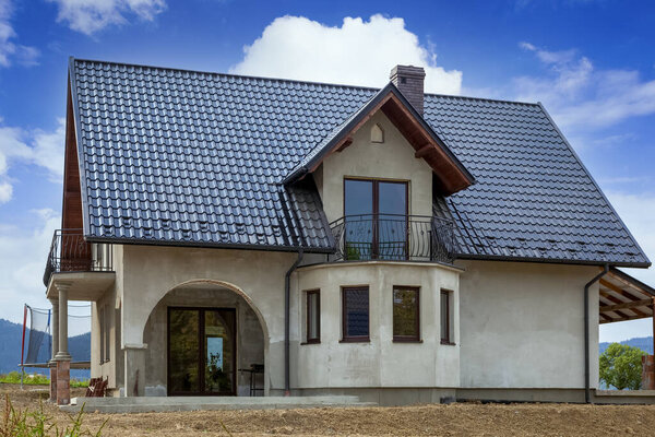 Single family house under construction on blue sky