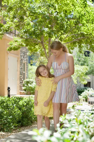 Portraitof happy mother with daughter  having good time in summer environment — Stock Photo, Image