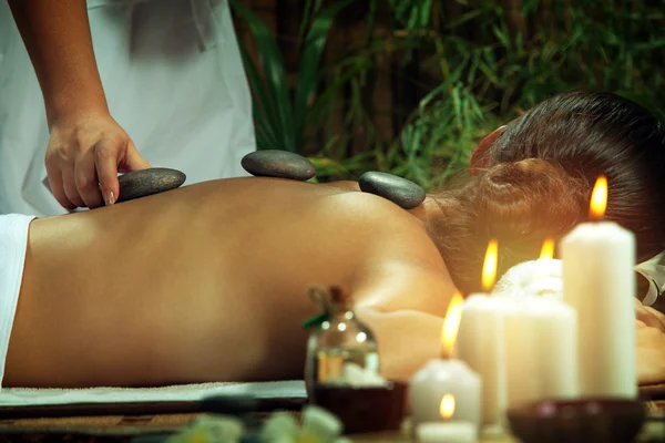 Portret van jonge mooie vrouw met massage in de spa omgeving. — Stockfoto