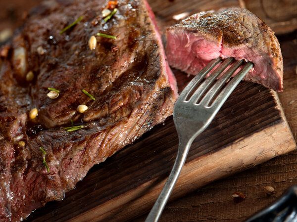 Close up view on nice fresh steak on color background