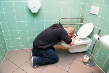man vomiting in the toilet clipart