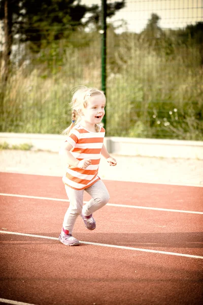 Little girl running on the treadmill — Stock Photo, Image