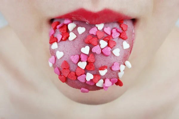 Lengua de mujer con corazón Fotos De Stock