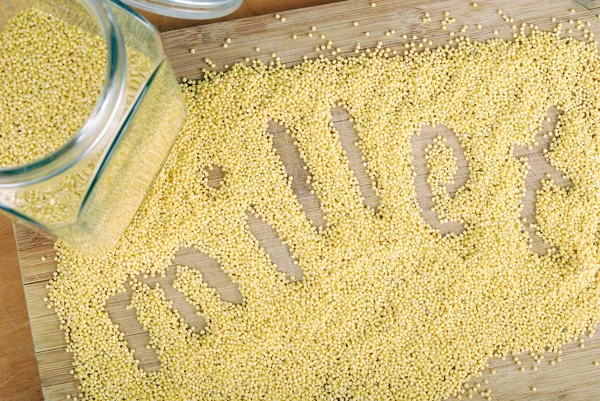 Millet on a wooden board — Stock Photo, Image