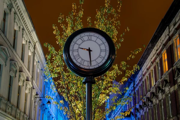 Clock on the street at night. Stock Image