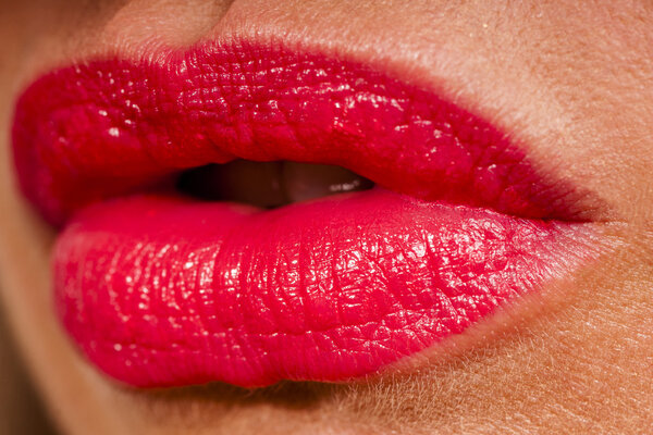 Beautiful woman with red shiny lips close up
