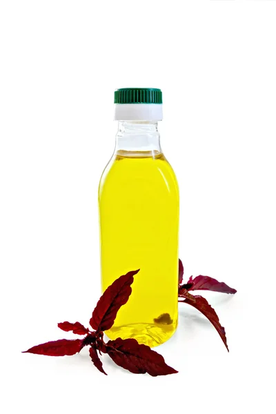 Oil with amaranth in bottle — Stock Photo, Image